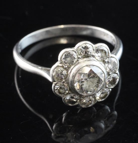 A 1920s platinum and diamond cluster ring, size K.